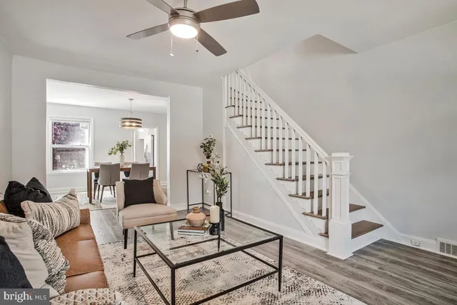 a living room with lots of furniture and wooden floor