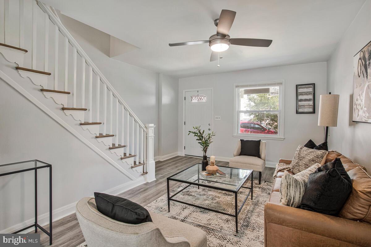 617 Annabel Avenue Baltimore, MD 21225 - Photo 9 of 40 a living room with furniture and a chandelier