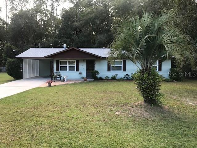 611 Northwest 9th Court Williston, FL 32696 - Photo 1 of 1 a front view of a house with garden
