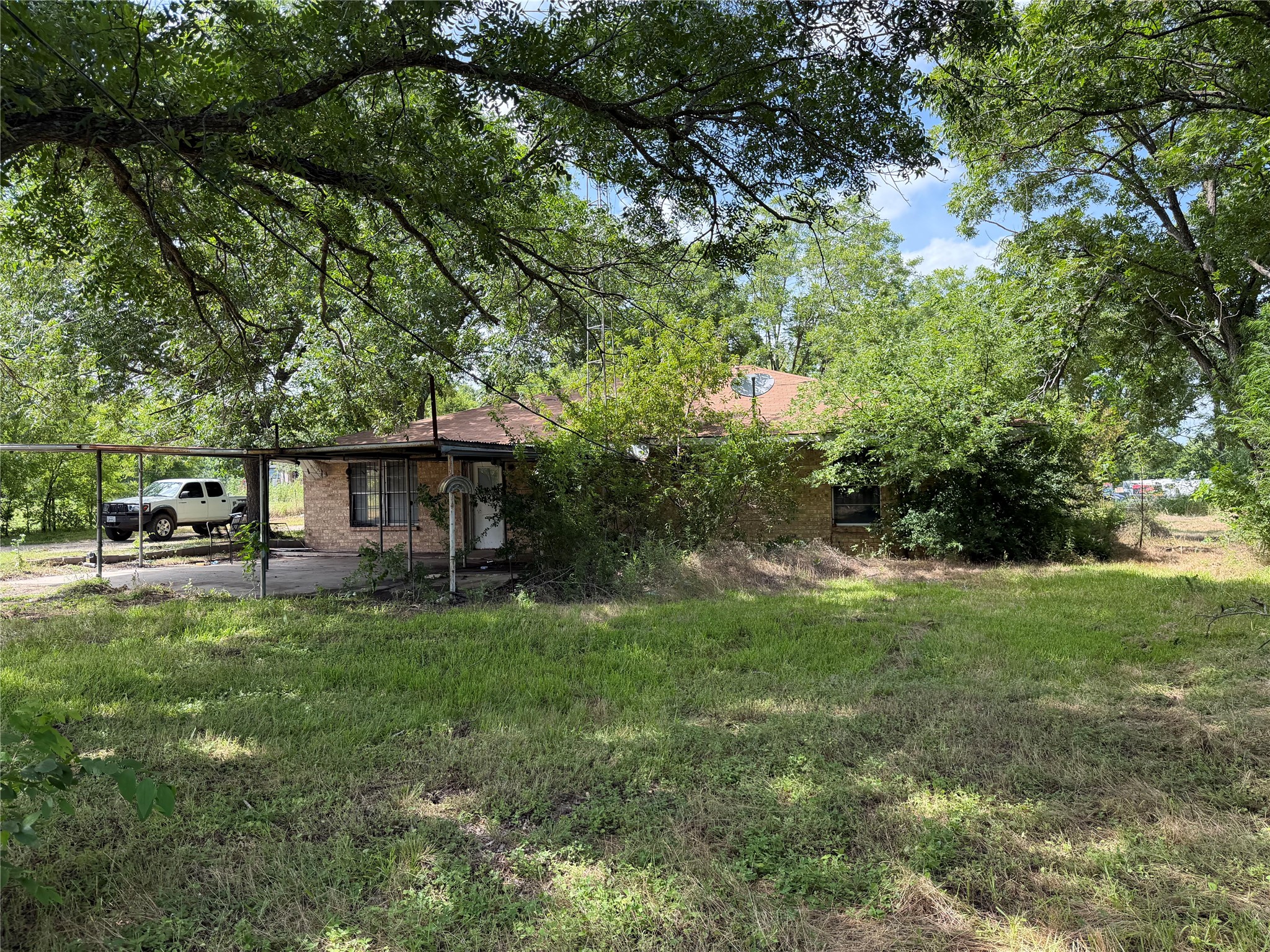 2501 Barnhardt Road Temple, TX 76502 - Photo 20 of 25 Mature trees shade this modest residence, offering a private, tranquil setting with ample parking.