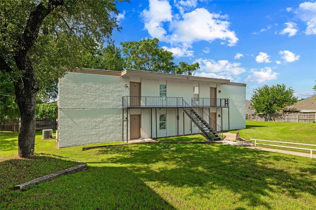 312 West Rentz Street, Unit 93 Weatherford, TX 76086 - Photo 7 of 15 Two-story building with a white painted brick exterior and a flat roof
