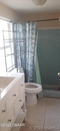 a view of an empty room with a wrought fence