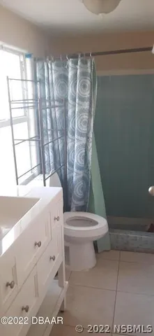 a view of an empty room with a wrought fence