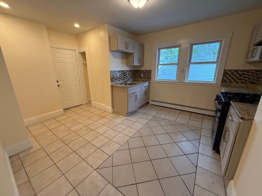 11 Dalrymple Street, Unit 3 Boston, MA 02130 - Photo 8 of 13 a kitchen with a sink a stove cabinets and a counter top space