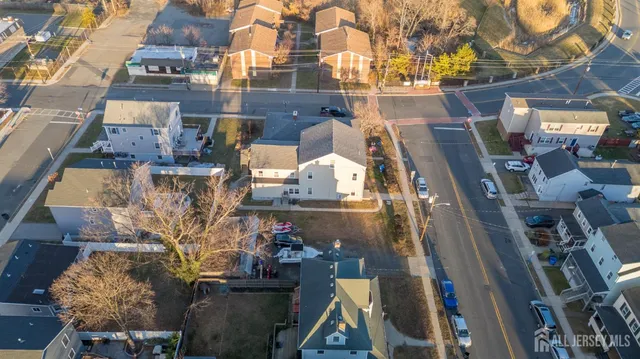 an aerial view of a residential apartment building with a yard