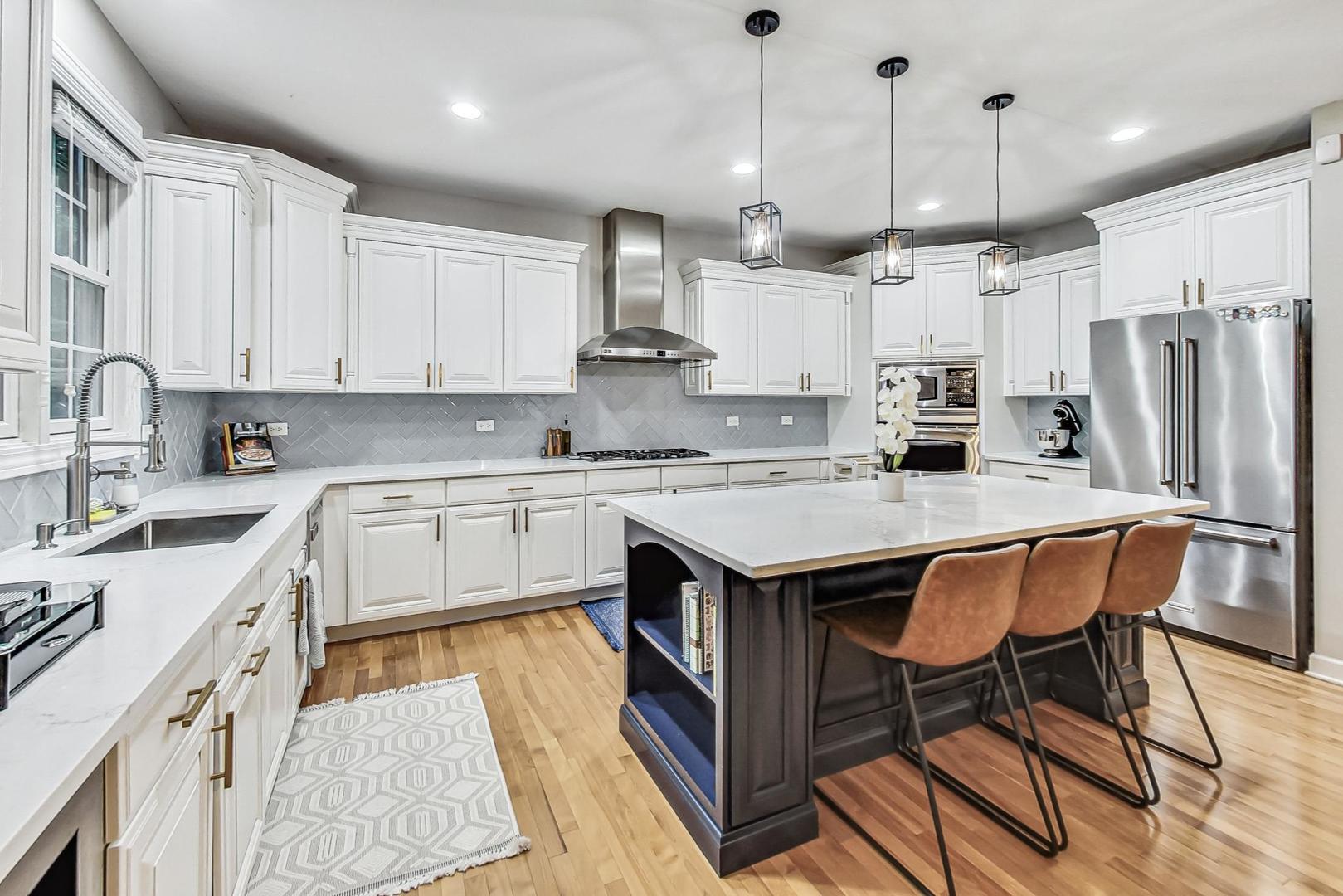 2680 Summit Drive Glenview, IL 60025 - Photo 14 of 70 a kitchen with stainless steel appliances granite countertop a sink a stove a refrigerator cabinets and chairs