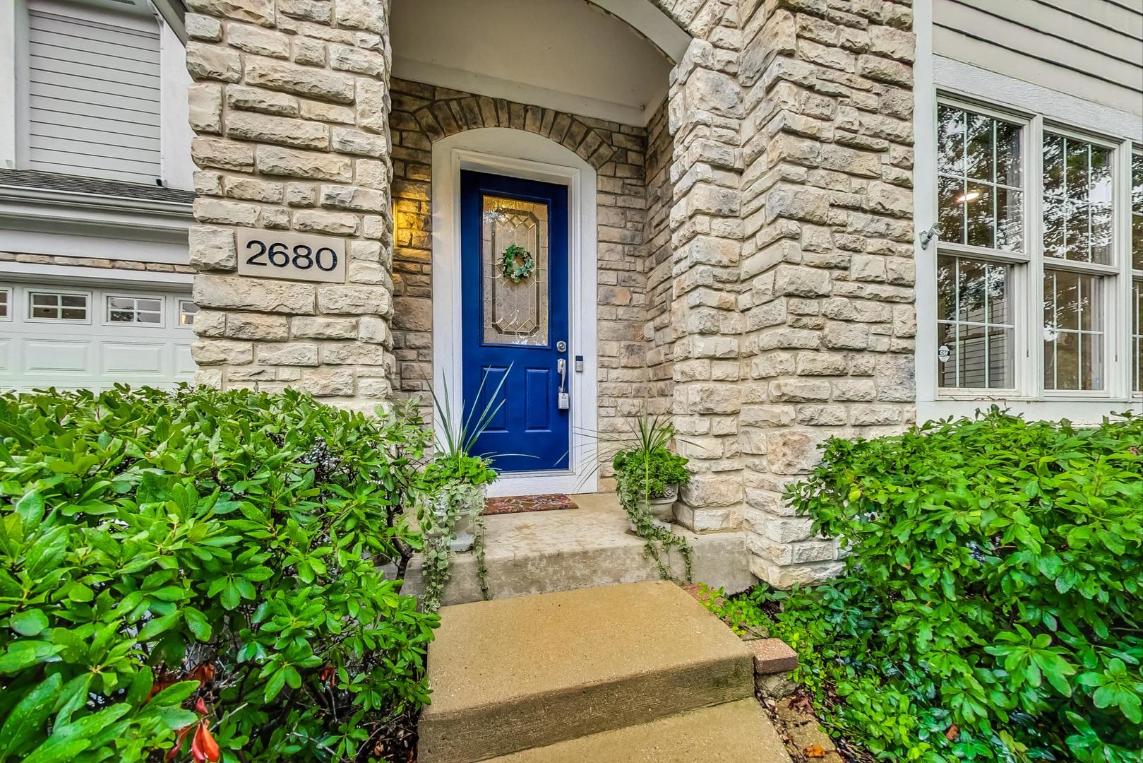 2680 Summit Drive Glenview, IL 60025 - Photo 2 of 70 a front view of a house with a garden