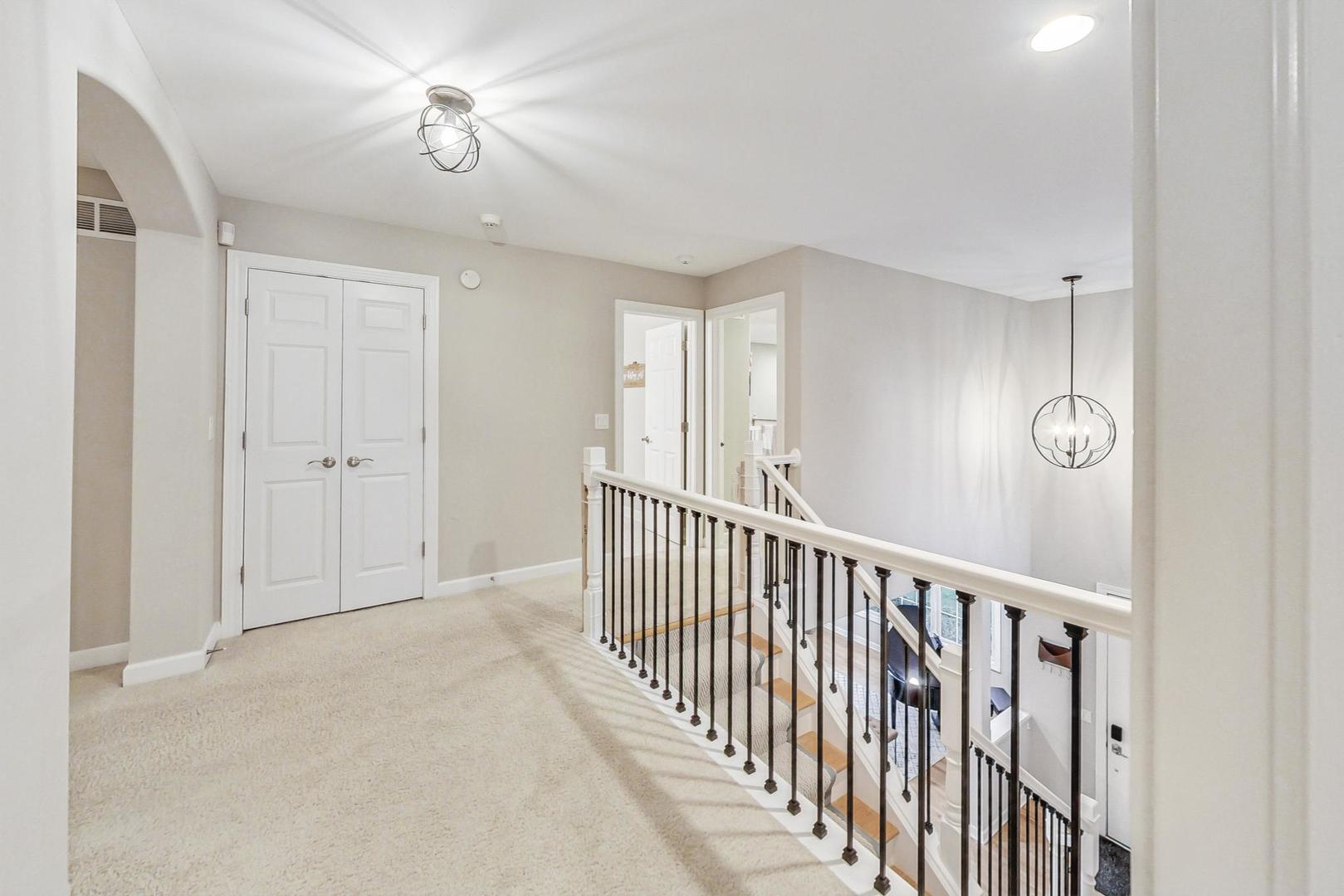 2680 Summit Drive Glenview, IL 60025 - Photo 25 of 70 a view of a hallway with a chandelier fan