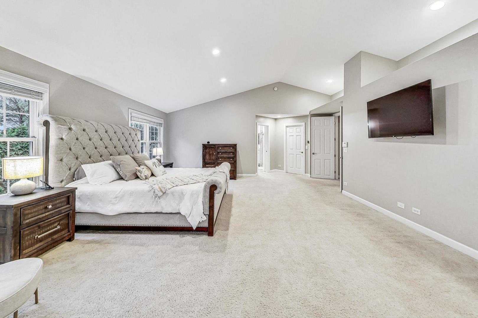 2680 Summit Drive Glenview, IL 60025 - Photo 30 of 70 a spacious bedroom with a bed and a flat screen tv