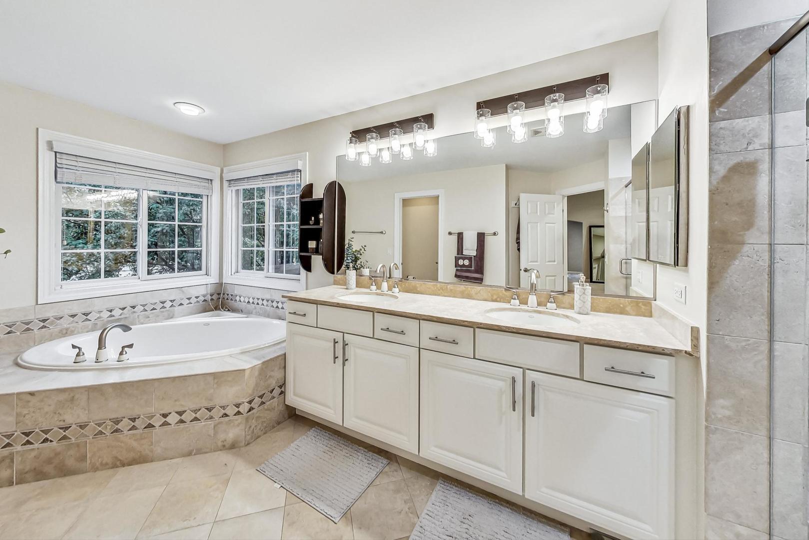 2680 Summit Drive Glenview, IL 60025 - Photo 31 of 70 a spacious bathroom with a tub sink and mirror