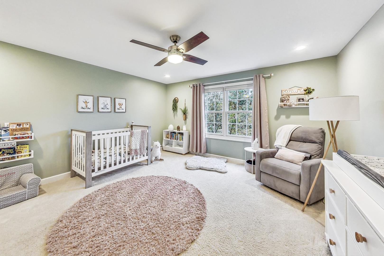 2680 Summit Drive Glenview, IL 60025 - Photo 42 of 70 a spacious bedroom with a bed a couch and a window