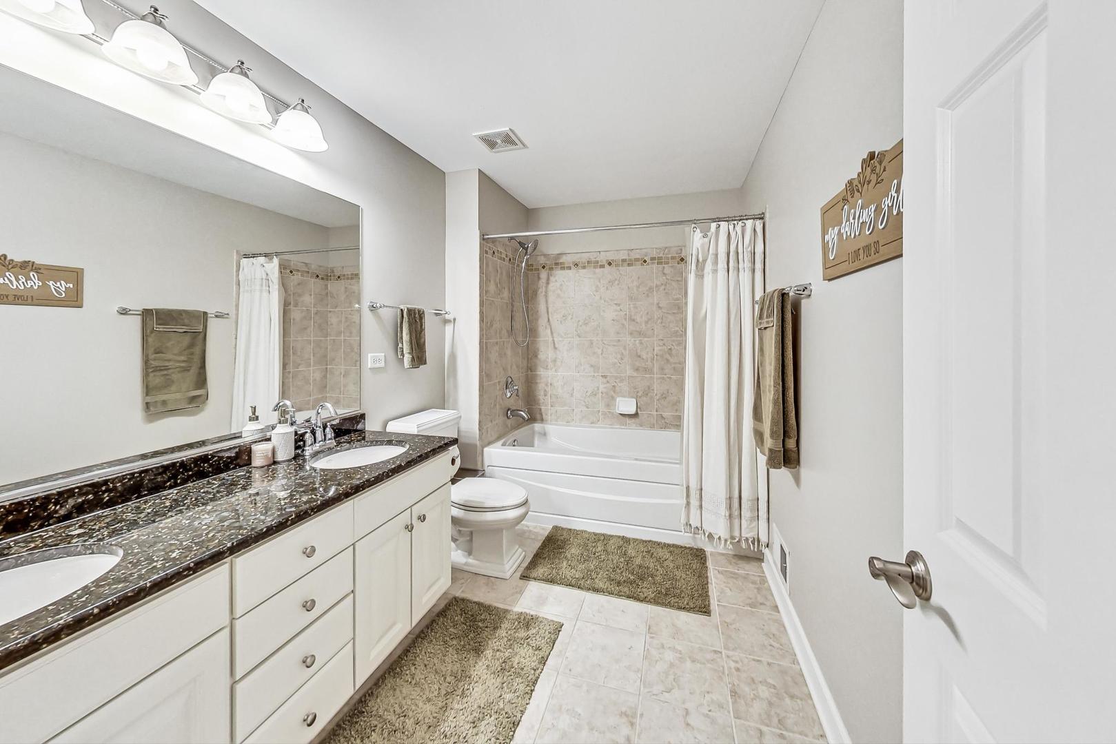 2680 Summit Drive Glenview, IL 60025 - Photo 45 of 70 a spacious bathroom with a double vanity sink a mirror a bathtub and shower