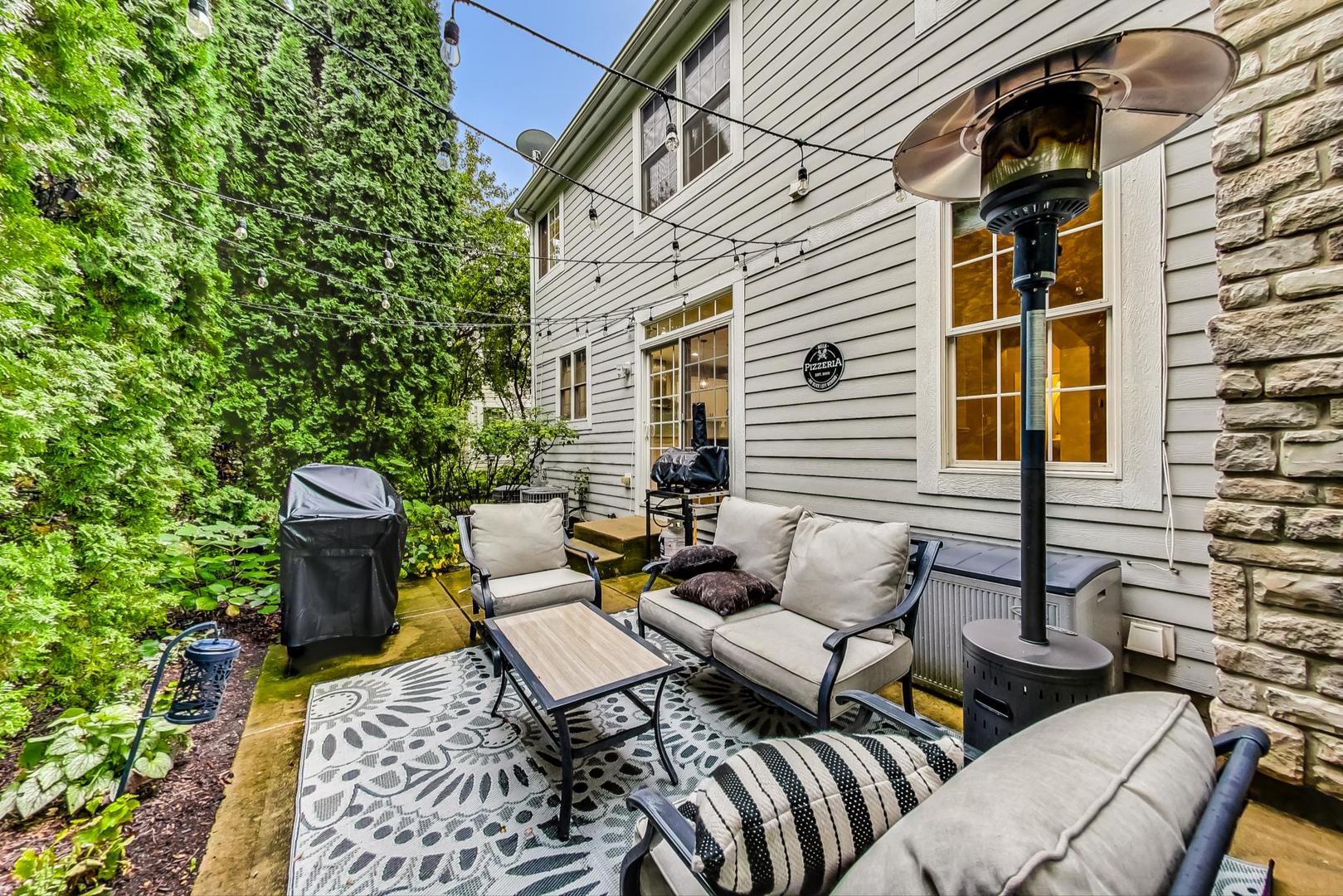 2680 Summit Drive Glenview, IL 60025 - Photo 61 of 70 a view of a patio with couches table and chairs and potted plants