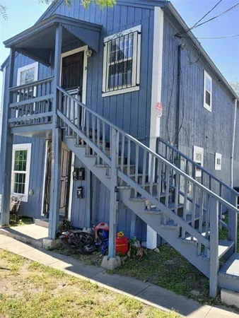 a view of a house with yard and wooden fence