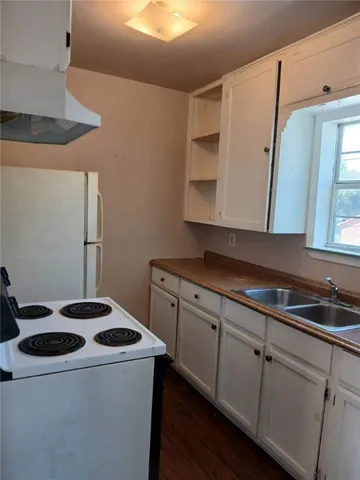 a kitchen with granite countertop a sink and a stove