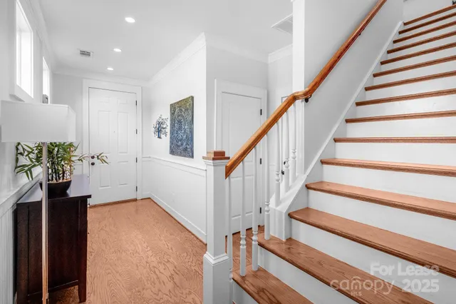 a view of entryway and hall with wooden floor