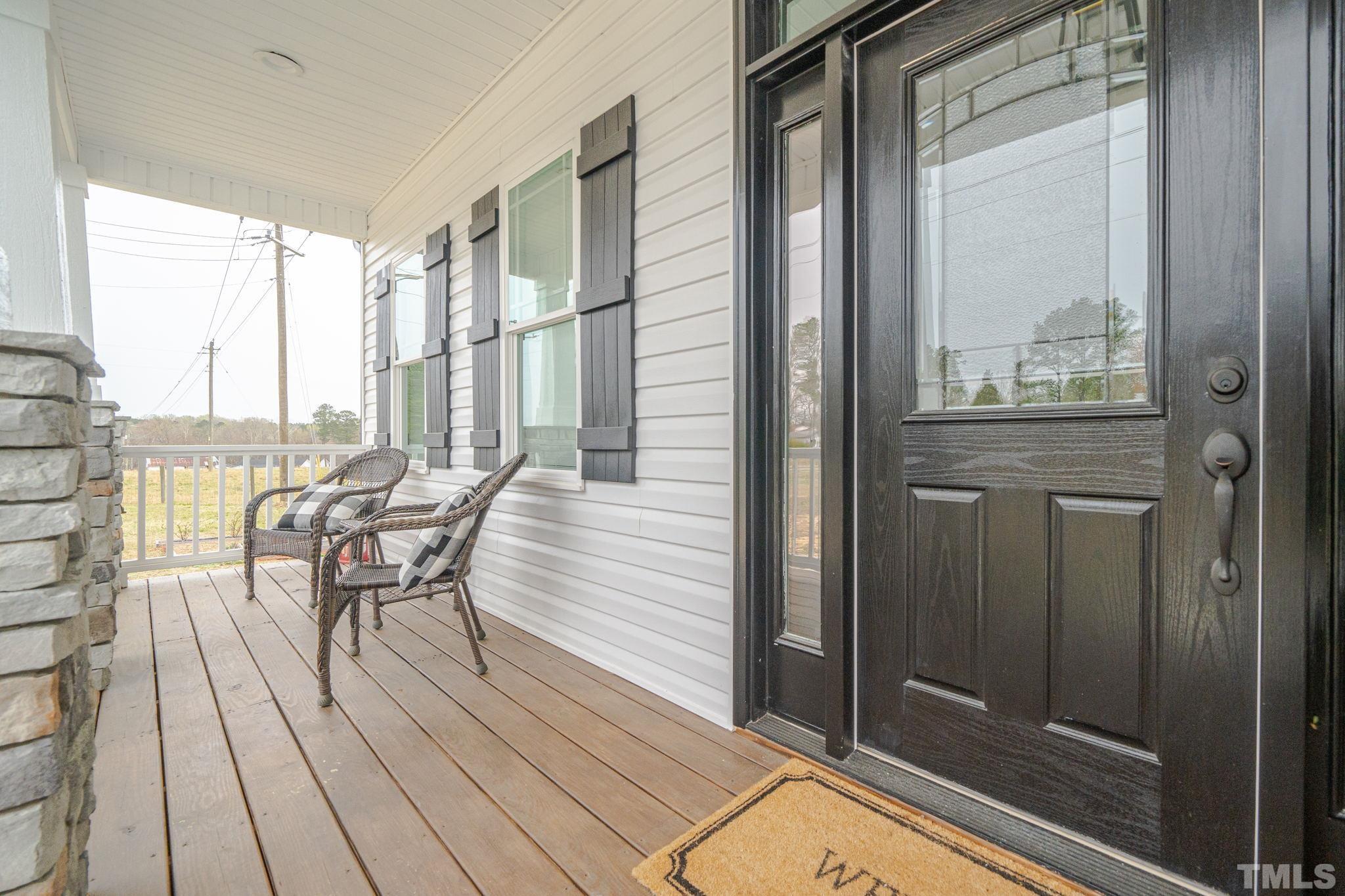 189 Brantleytown Road Zebulon, NC 27597 - Photo 7 of 46 a view of a balcony with chairs and wooden floor