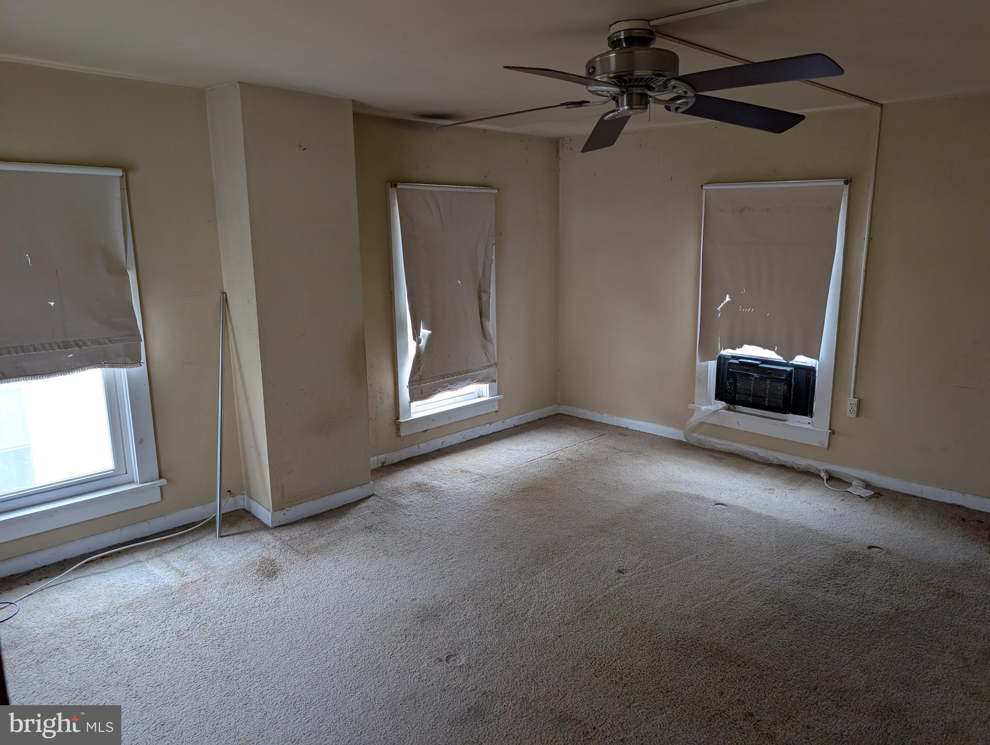 6 West State Street Delmar, MD 21875 - Photo 8 of 10 an empty room with windows and cabinet