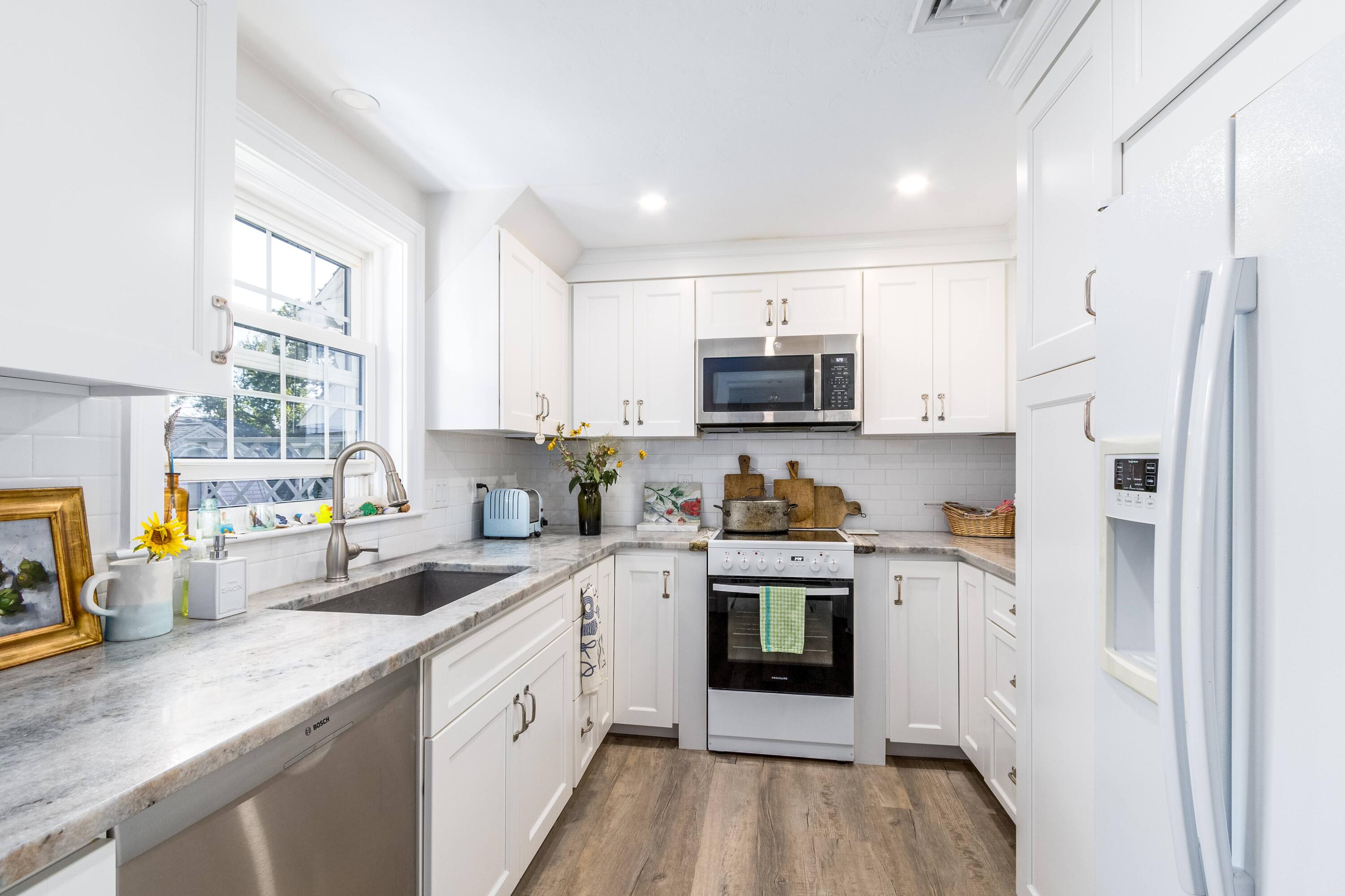 920 Main Street, Unit 4 Osterville, MA 02655 - Photo 14 of 28 a kitchen with stainless steel appliances a sink a stove a refrigerator cabinets and a window