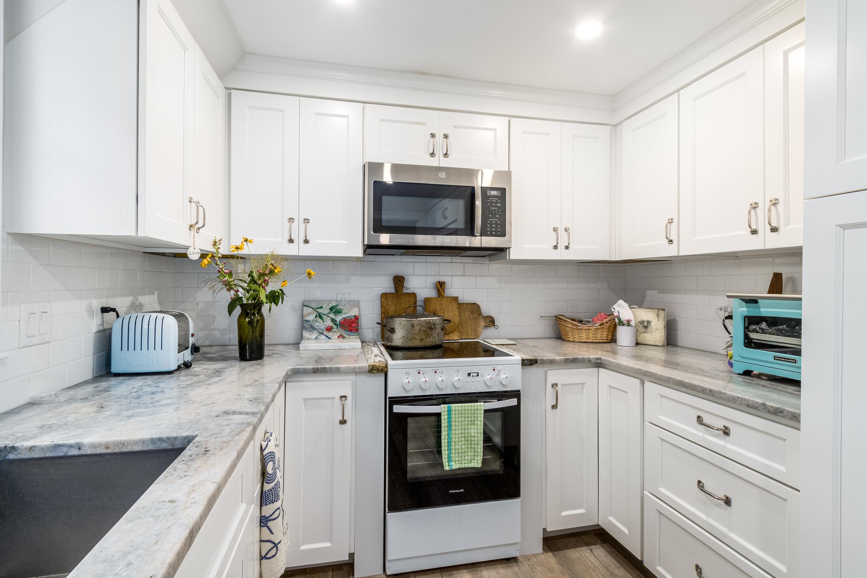 920 Main Street, Unit 4 Osterville, MA 02655 - Photo 15 of 28 a kitchen with granite countertop white cabinets and white appliances