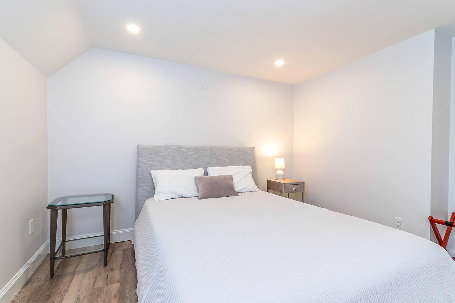 920 Main Street, Unit 4 Osterville, MA 02655 - Photo 24 of 28 a bedroom with a bed and a table