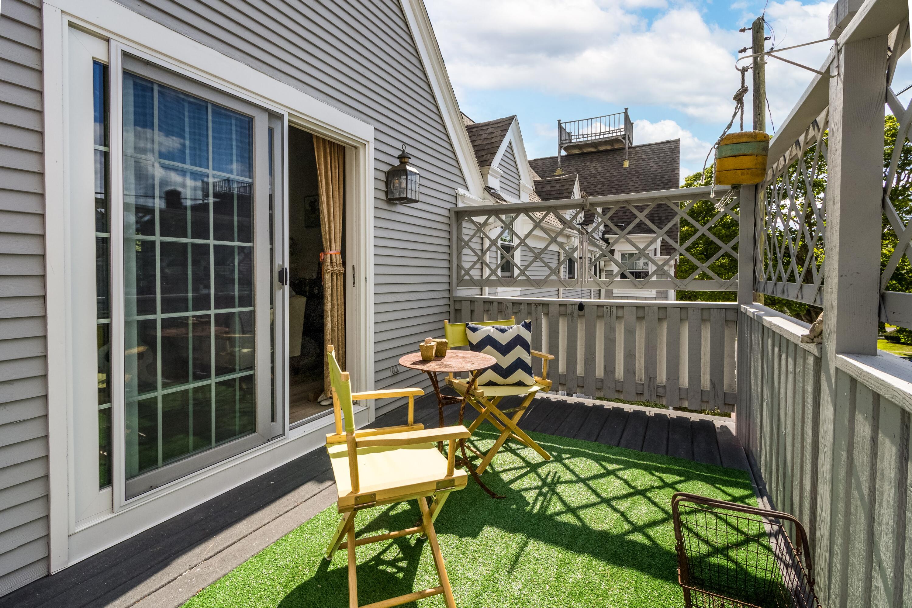 920 Main Street, Unit 4 Osterville, MA 02655 - Photo 27 of 28 a balcony with table and chairs