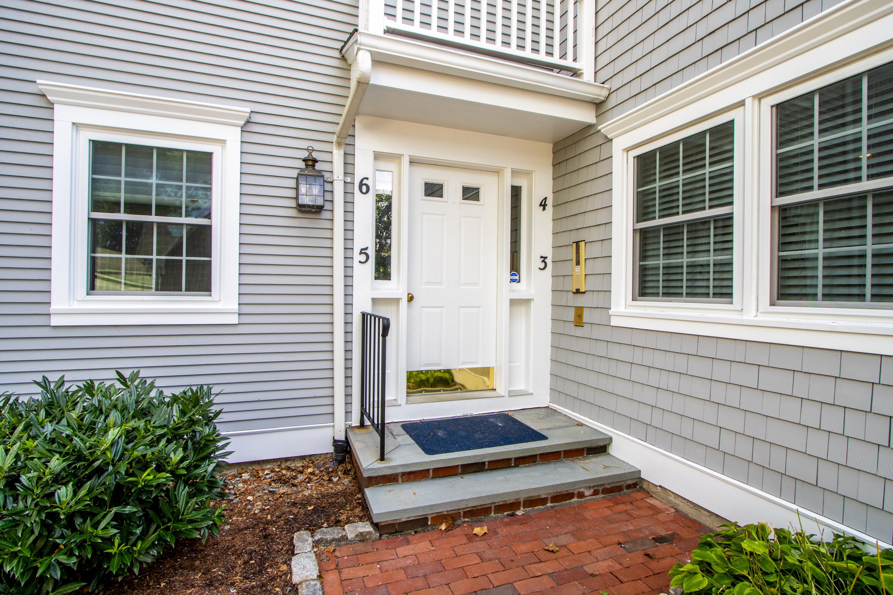 920 Main Street, Unit 4 Osterville, MA 02655 - Photo 4 of 28 a house with a potted plant in front of door