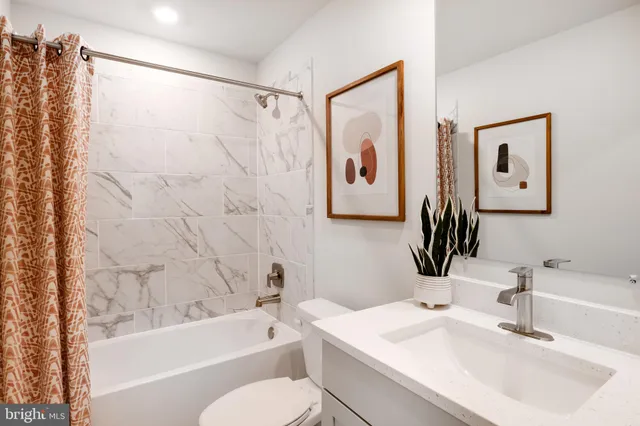 a bathroom with a sink a toilet and a bathtub