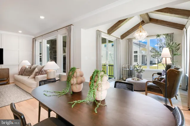 a living room with furniture and floor to ceiling windows