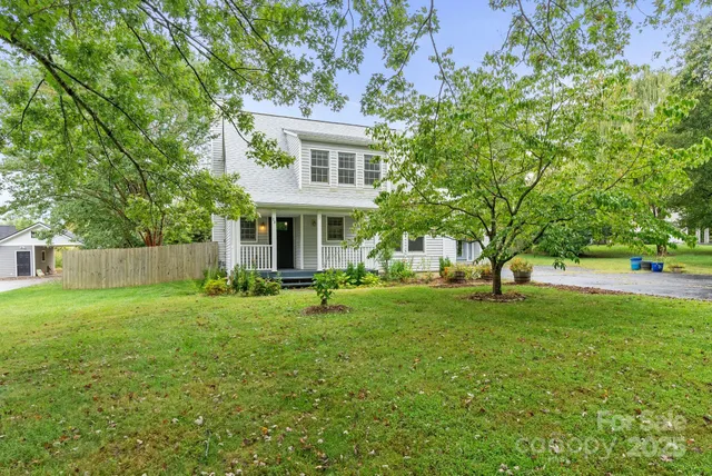 a view of a house with a yard and sitting area
