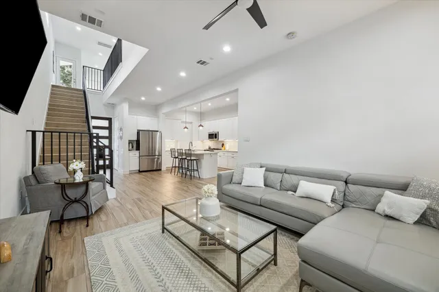 a living room with furniture and a wooden floor
