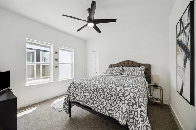 a bedroom with a bed dresser and a window