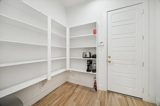 a view of walk in closet with empty racks