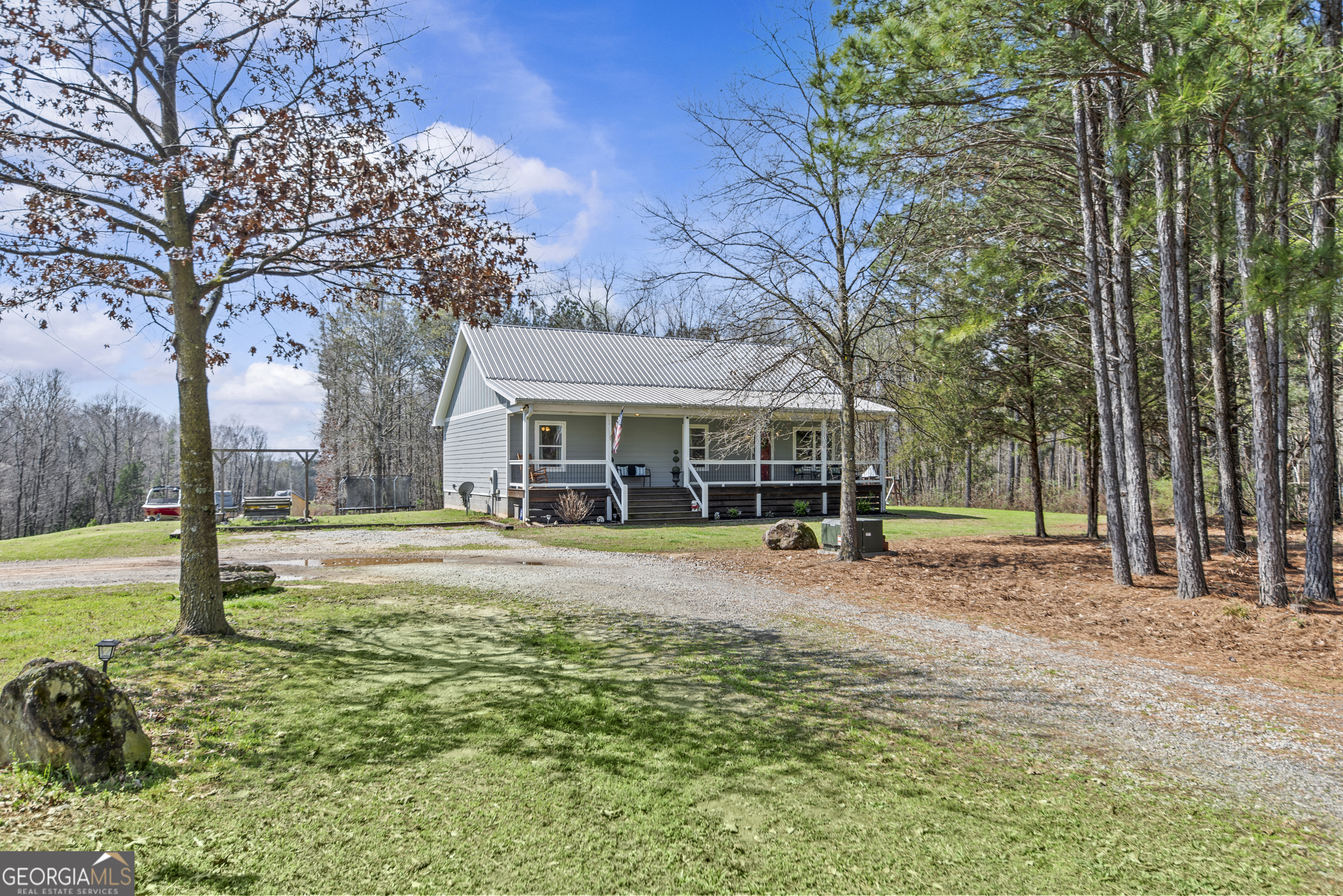 a view of a house with swimming pool and porch with furniture