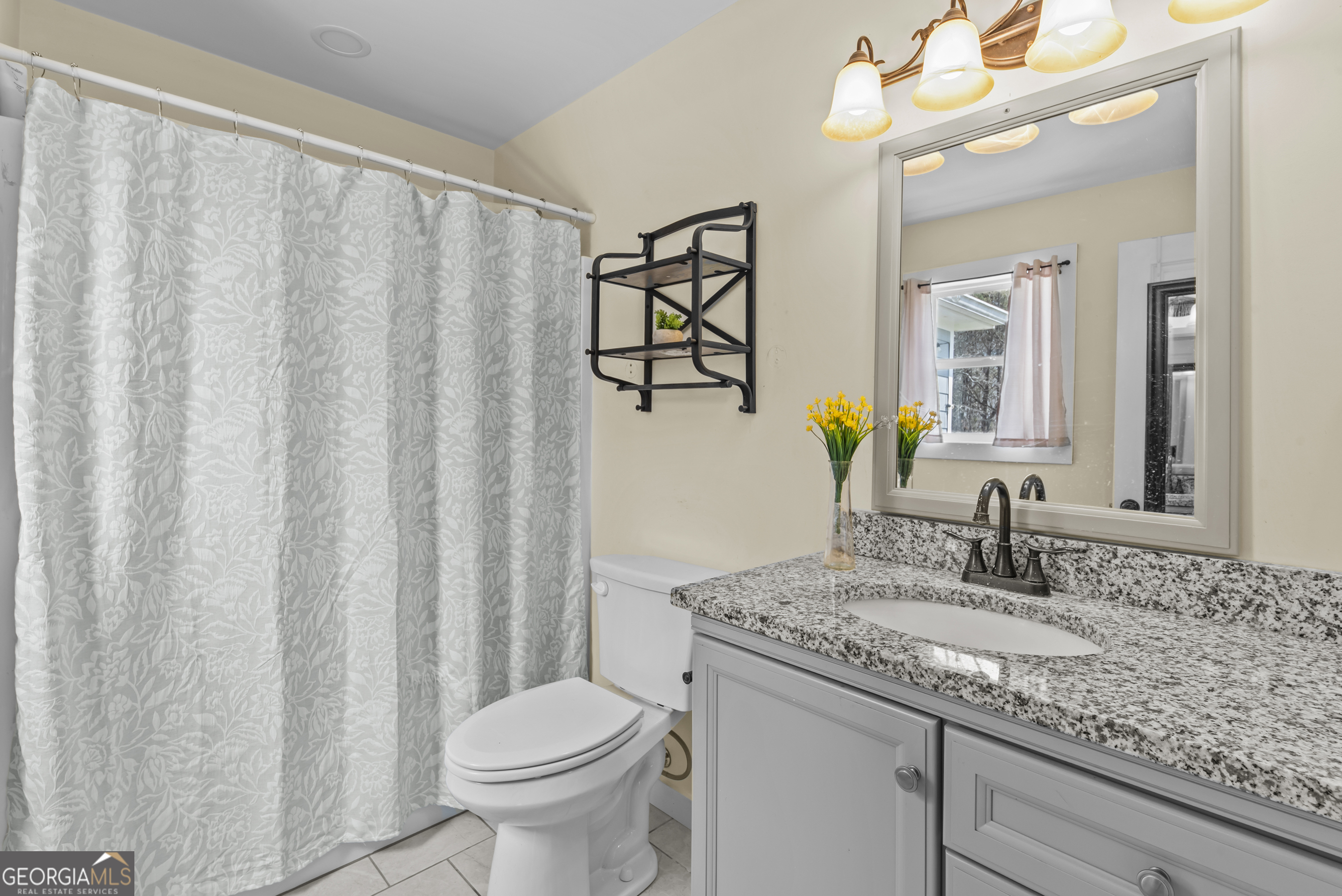 1687 Leon Ellis Road Hull, GA 30646 - Photo 13 of 51 a bathroom with a granite countertop sink and a mirror