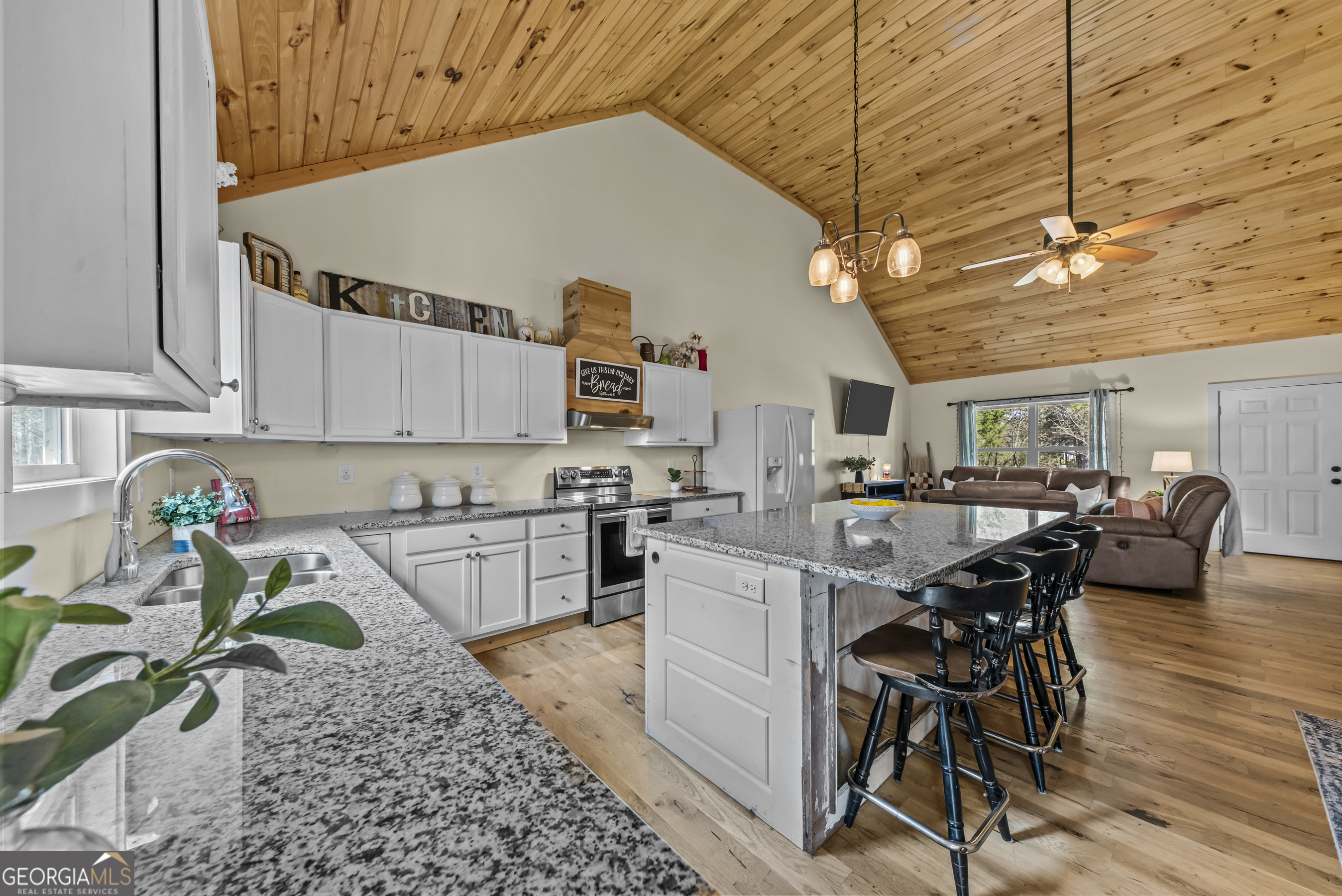 1687 Leon Ellis Road Hull, GA 30646 - Photo 9 of 51 a kitchen with a table chairs and white cabinets