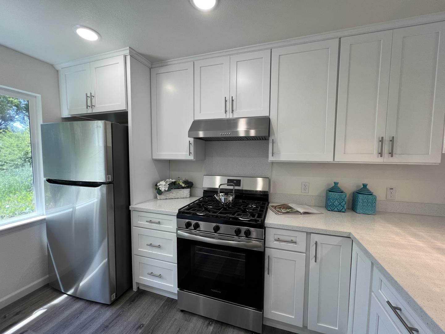 1311 Lexington Road Concord, CA 94520 - Photo 11 of 25 a kitchen with stainless steel appliances white cabinets and a stove a refrigerator with wooden floor