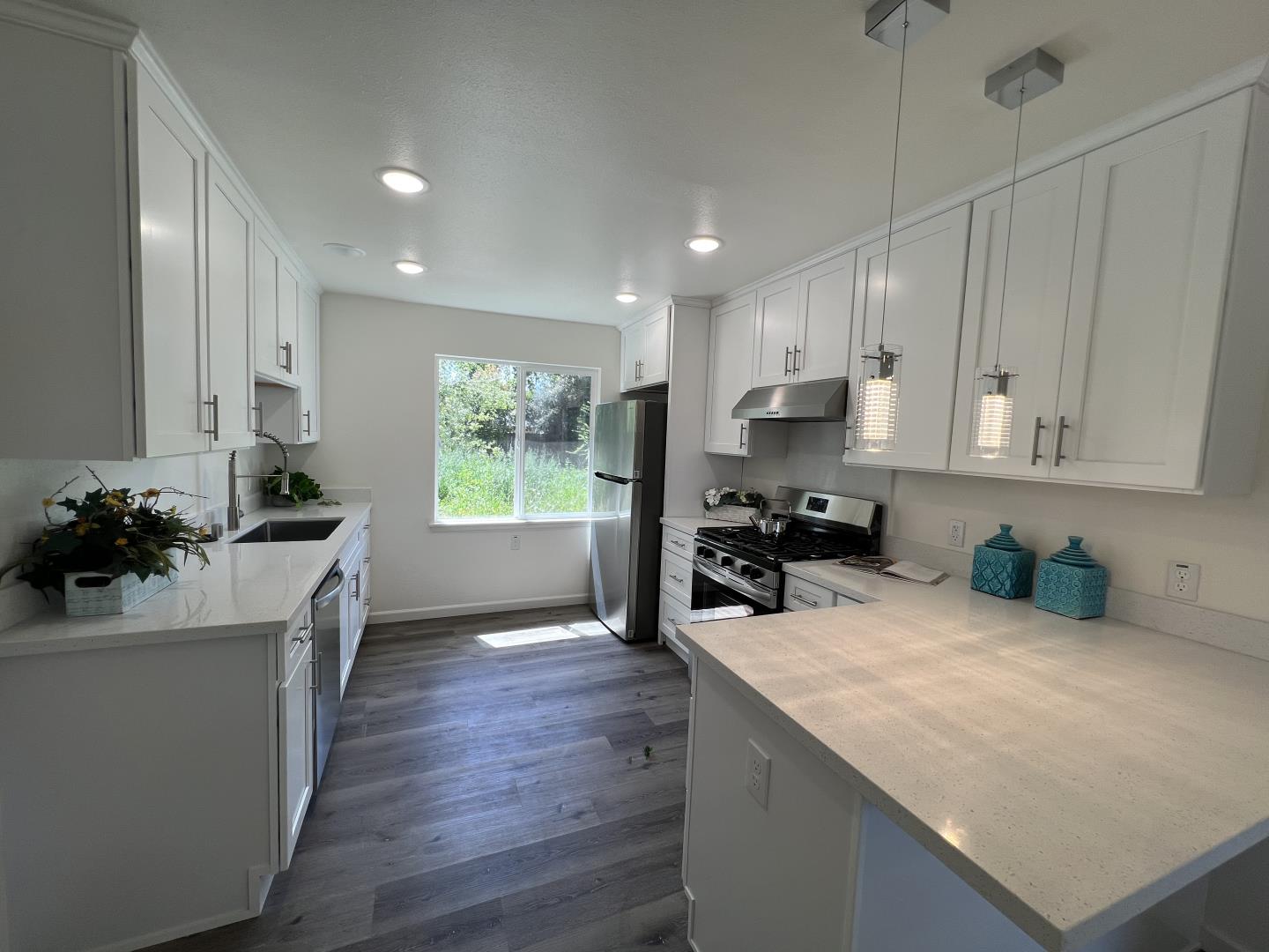 1311 Lexington Road Concord, CA 94520 - Photo 13 of 25 a kitchen with sink cabinets and wooden floor