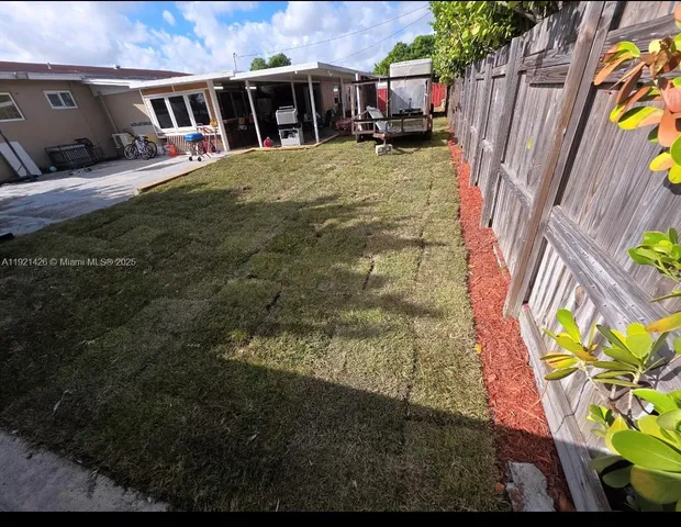 a view of swimming pool with a yard and plants
