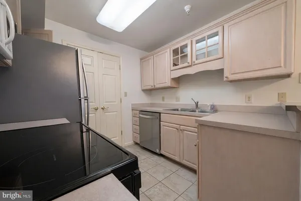 a kitchen with a stove cabinets and a refrigerator