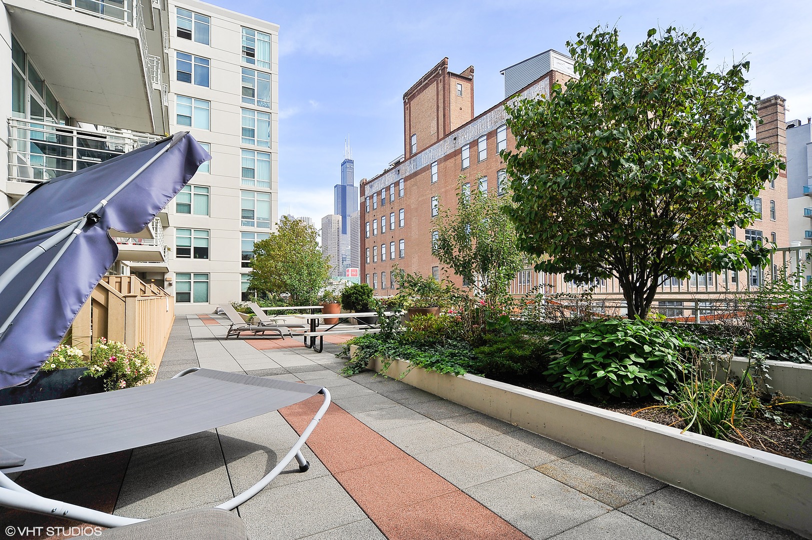 909 West Washington Boulevard, Unit 701 Chicago, IL 60607 - Photo 24 of 25 a view of a building with garden and sitting area
