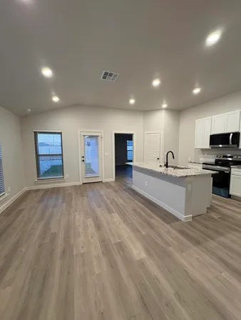 a view of kitchen with microwave and cabinets