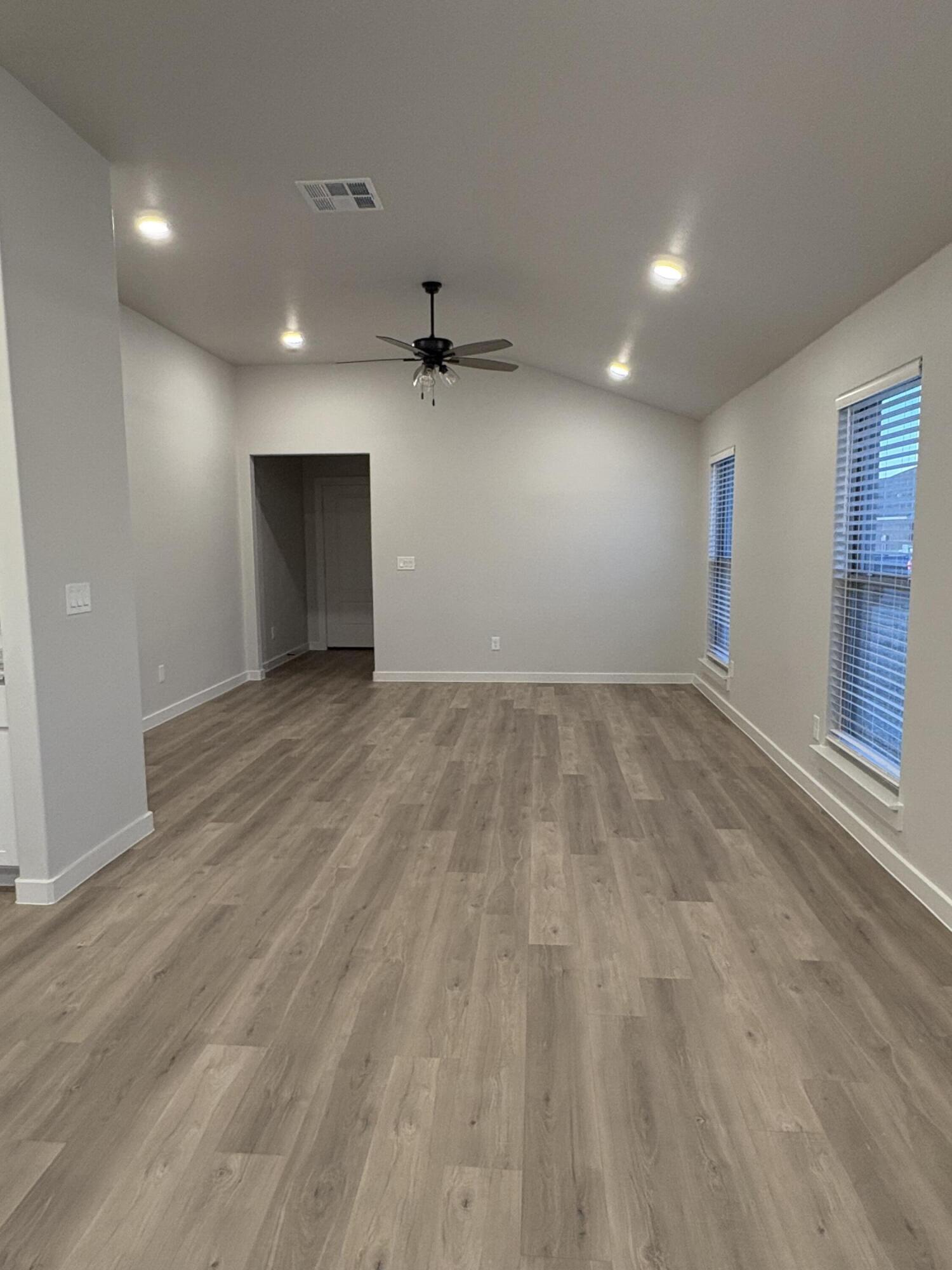 2121 Langford Avenue Lubbock, TX 79407 - Photo 4 of 4 an empty room with wooden floor and windows