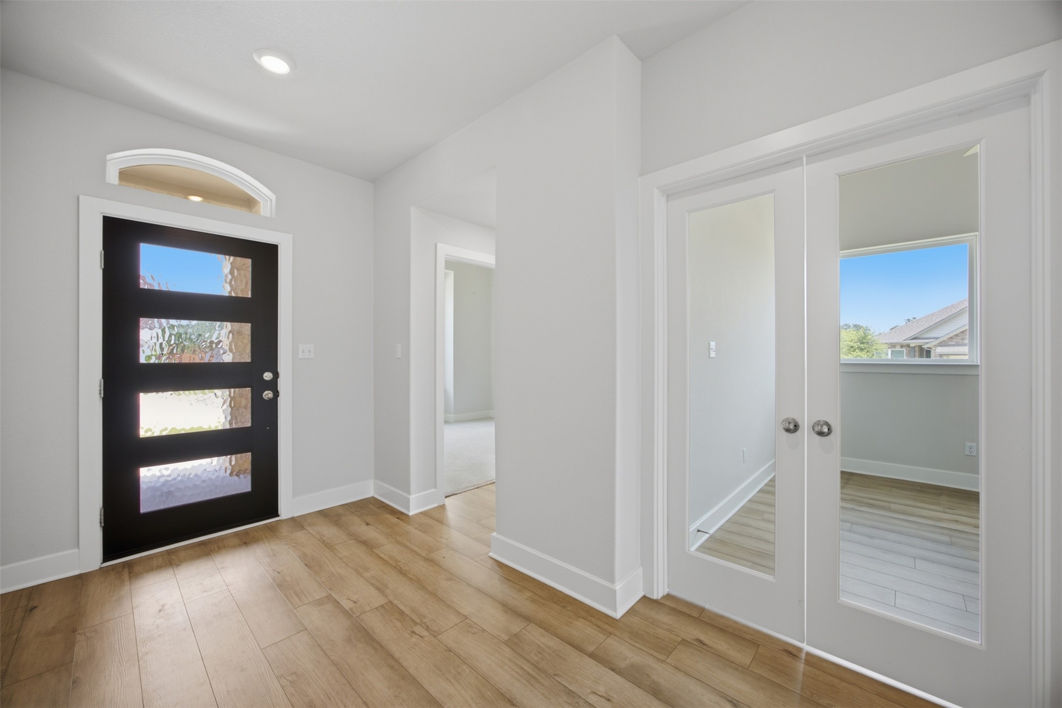 2101 Little Snake Way Georgetown, TX 78633 - Photo 6 of 37 A welcoming entryway with recessed lighting illuminates the warm hardwood-style flooring.