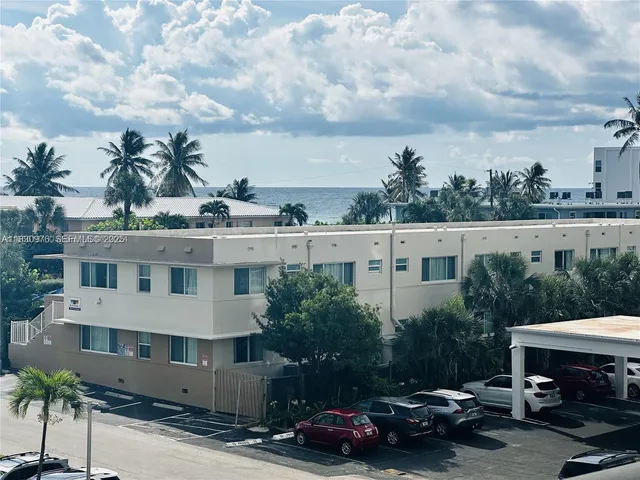 a couple of cars parked in front of a building
