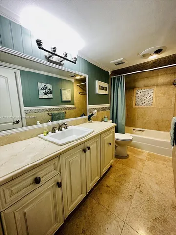 a bathroom with a granite countertop sink mirror and bathtub