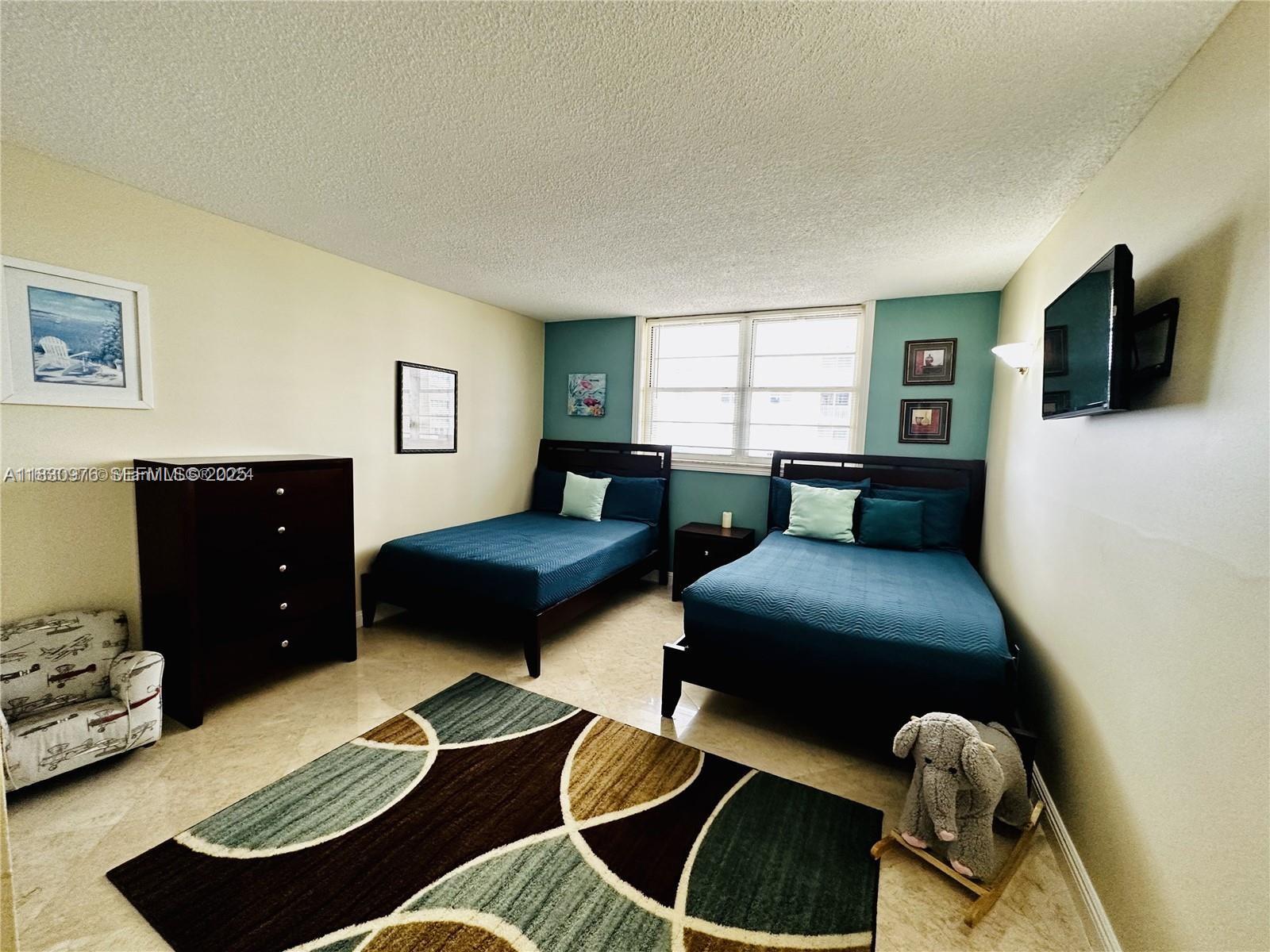 1501 South Ocean Drive, Unit 406 Hollywood, FL 33019 - Photo 7 of 14 a bedroom with furniture and a window
