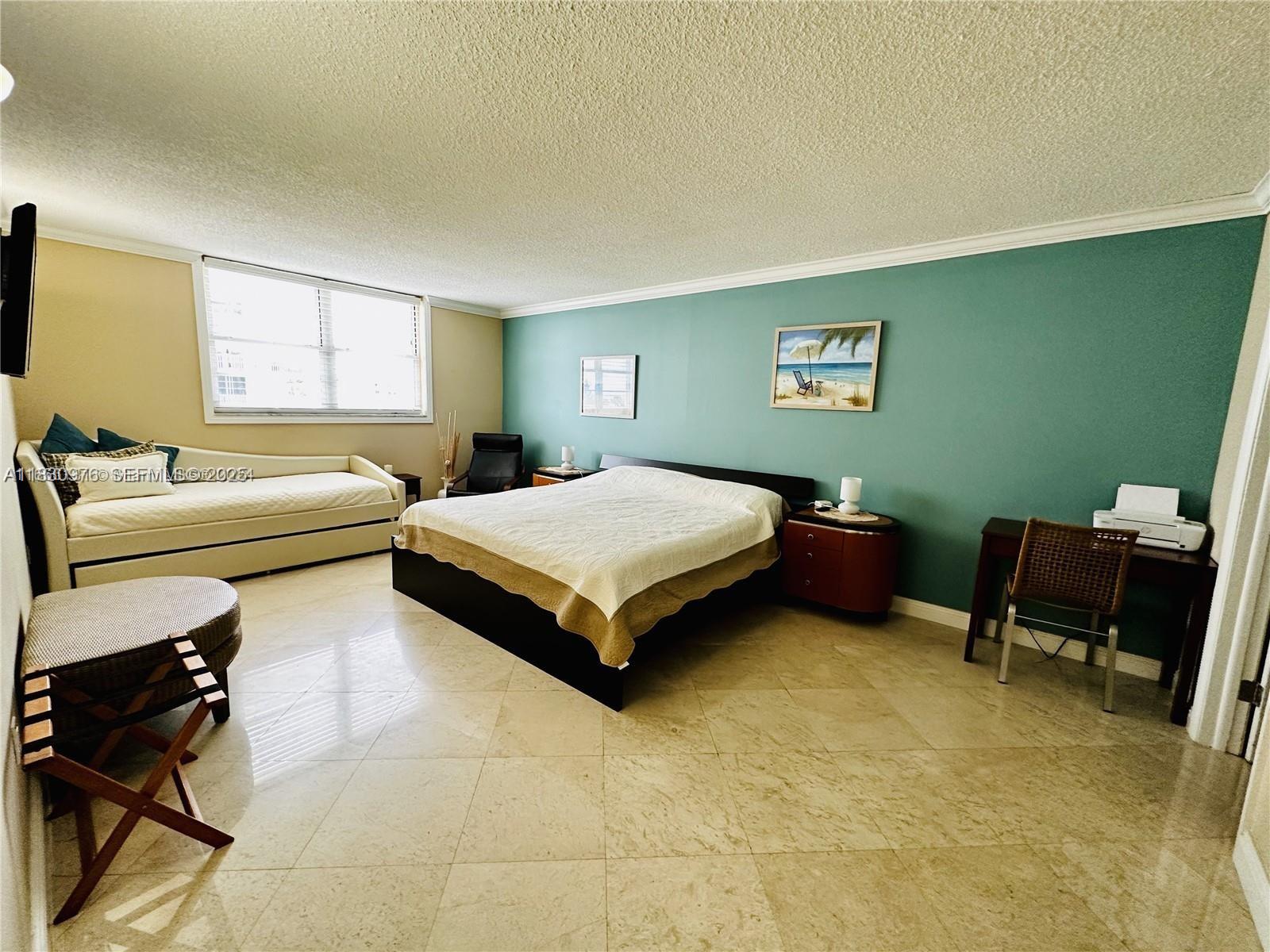 1501 South Ocean Drive, Unit 406 Hollywood, FL 33019 - Photo 8 of 14 a bedroom with a bed and a chair