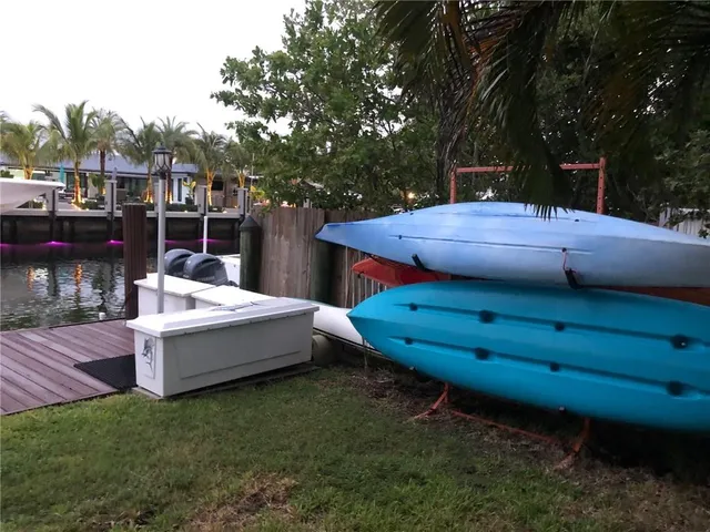 a view of a backyard with a table and chairs
