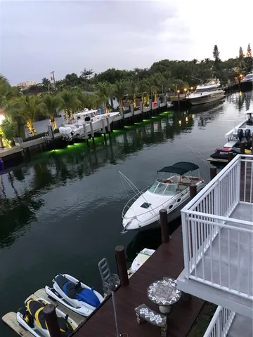a balcony with wooden floor and lake view